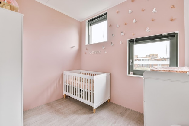 Light cozy baby room with cot