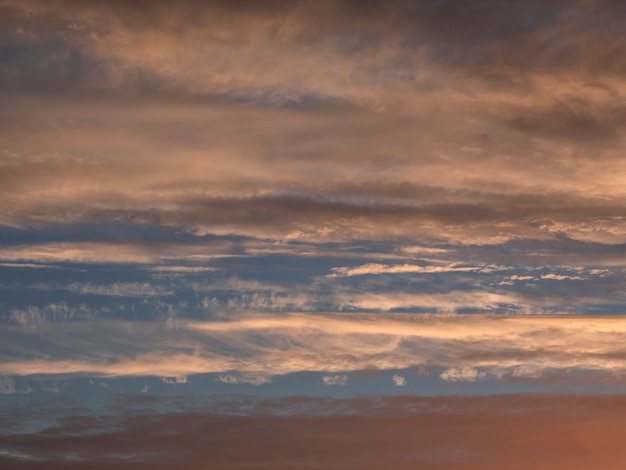 Light evening Ñumulus clouds in the sky. Colorful cloudy sky at sunset. Sky texture, abstract nature background