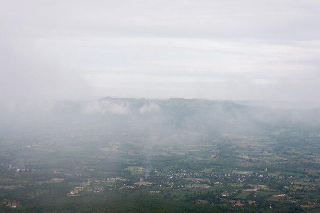 The light fog is floating over the countryside village.