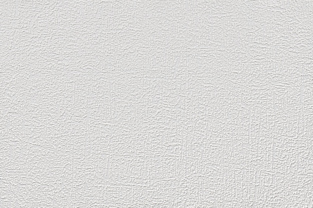 Light gray background of textured paper wallpaper with small uneven strokes