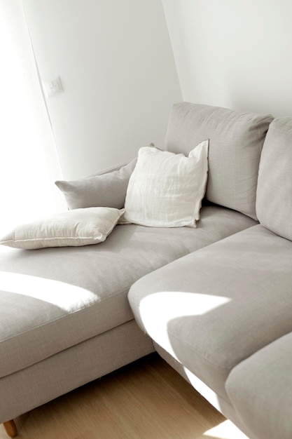 Light gray sofa next to window