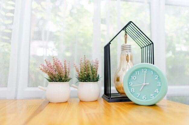 Light green alarm clock Placed on the table in the bedroom