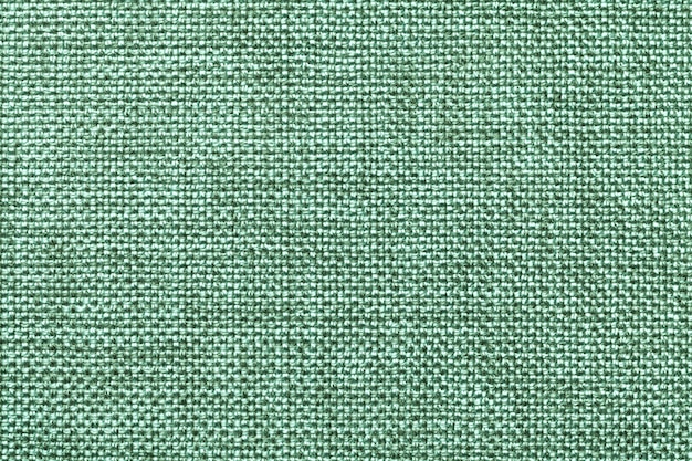 Light green textile background closeup. Structure of the fabric macro