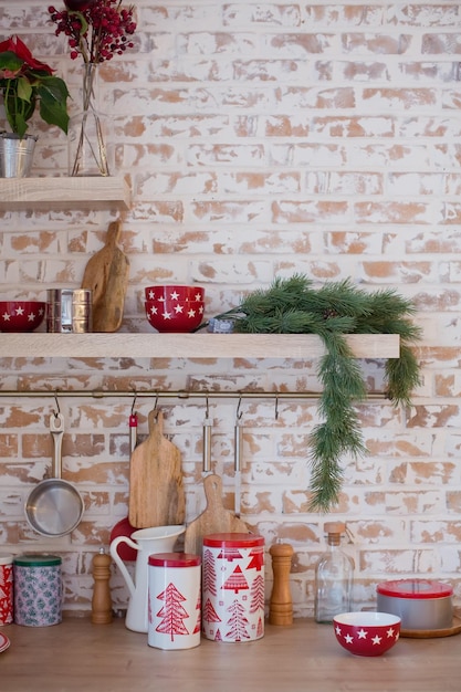 Photo light kitchen with brick walls and red christmas decorations and lights