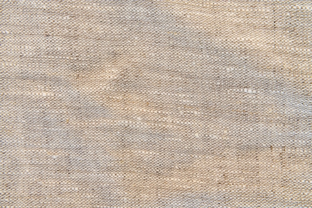 Foto texture leggera in lino naturale per lo sfondo. trama di lino tessuto naturale per il design. tela di sacco testurizzata.