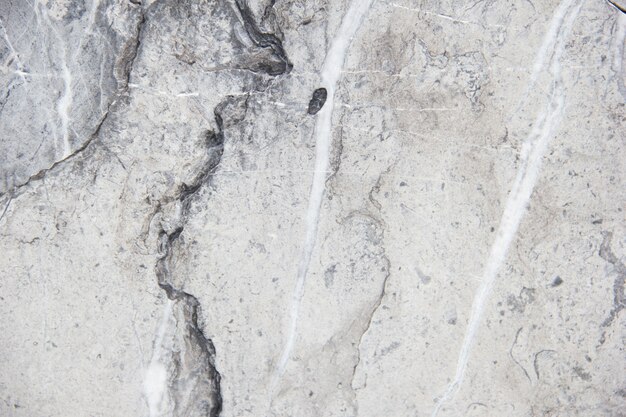 Photo light natural stone with streaks. marble texture. gentle warm cream. stone background