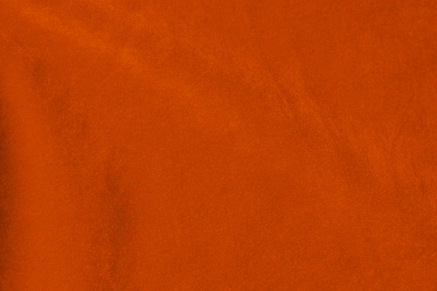 Foto tessuto di velluto arancione chiaro usato come sfondo colore seta tessuto zafferano sfondo di materiale tessile morbido e liscio velluto schiacciato lusso sole tono chiaro per la seta