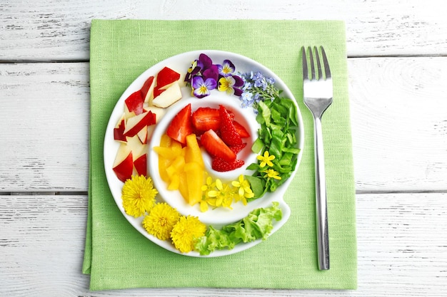 Light organic salad with flowers close up