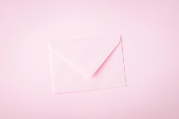 Light paper envelope on pink background