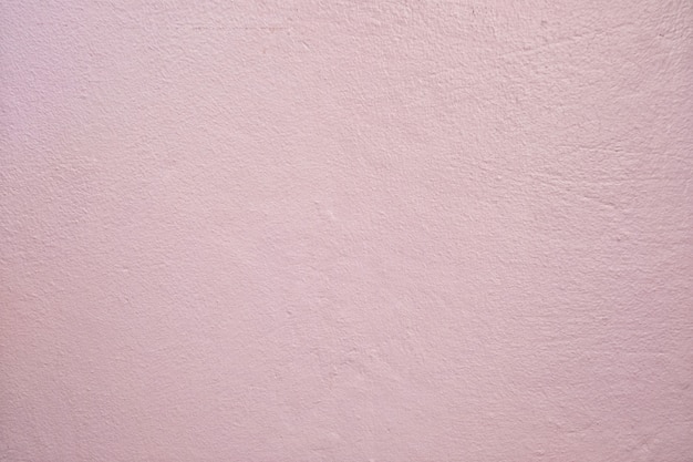 Photo light pink dirty cement wall background.