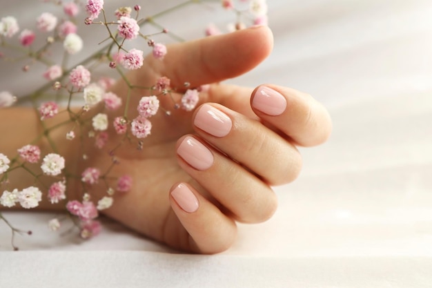 Light pink manicure on short nails with Gypsophila