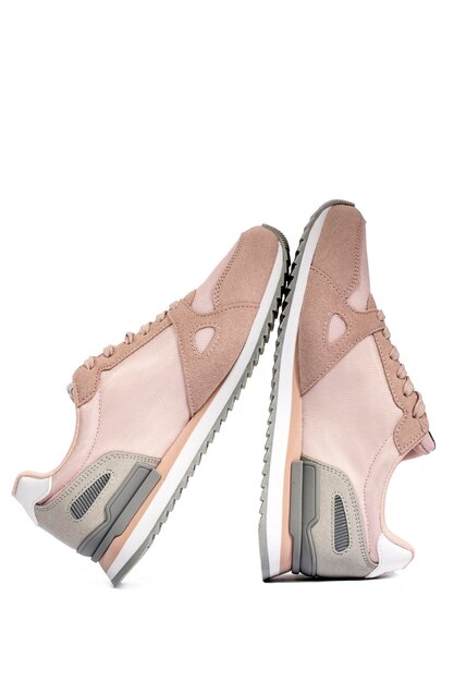 Light pink summer sneakers on a white background