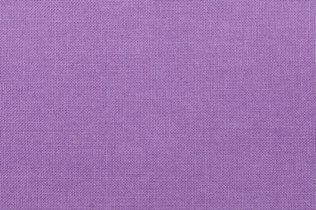 Light purple background from a textile material. Fabric with natural texture. Backdrop.