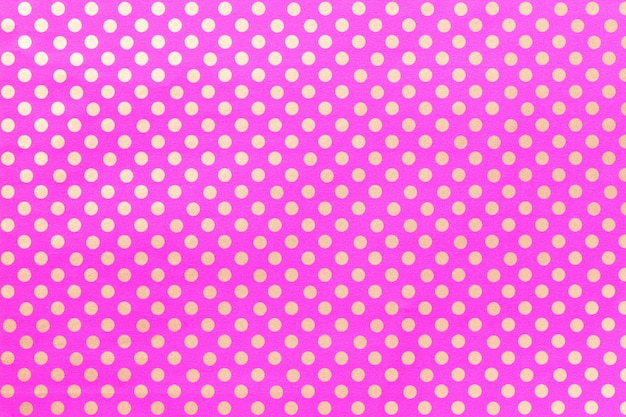 Light purple background from wrapping paper with a design of polka dot closeup.