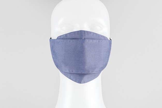 Photo light purplish-blue fabric face mask on a dummy head