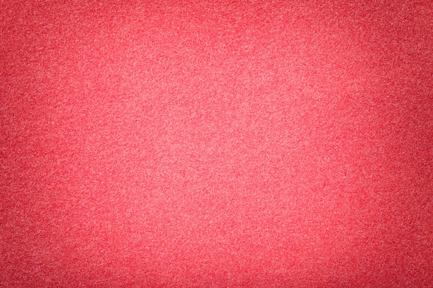 Light red matt suede fabric closeup. Velvet texture of felt.