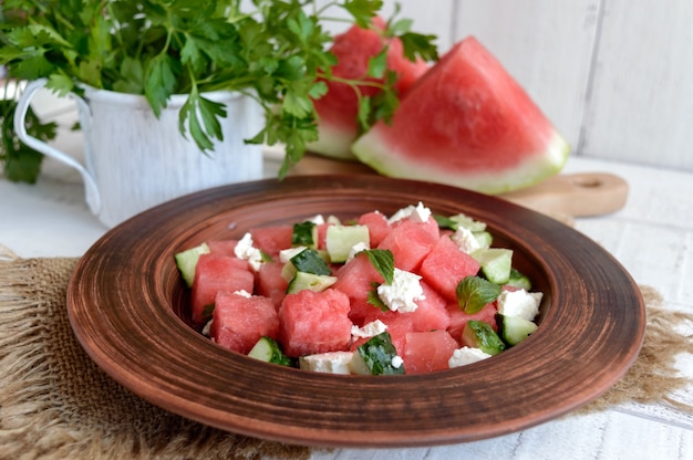 Light refreshing dietary gourmet salad with fresh watermelon, cucumbers and feta cheese