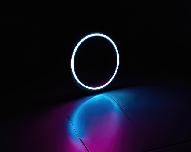 Light rings pink and blue magenta and turquoise with reflections on the floor black background moving light rings