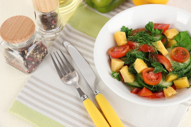 Light salad in plate on wooden table