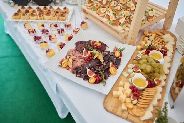 light snacks for the holiday catering Various light snacks Catering plate Assortment of sandwiches on the buffet table meat fish vegetable canapes