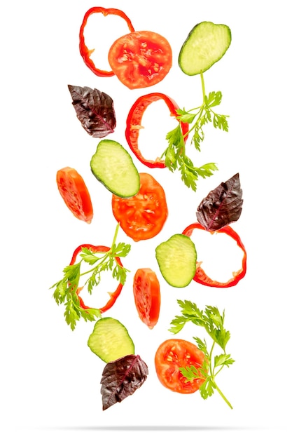 Light spring summer salad with flying floating in air ingredients fresh vitamin vegetables Suspended tomato cucumber pepper parsley basil Vegetarian vegan healthy food menu