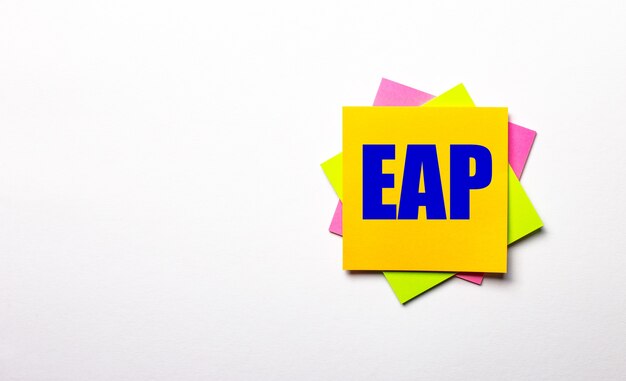 On a light surface - bright multicolored stickers with the text EAP Employee Assistance Program