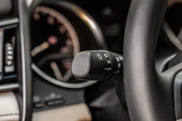 Light switch control. Close up of car light switch and control. Modern car interior detail.