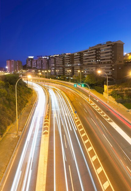 Light trails on road in city against clear sky at night in alicante spain