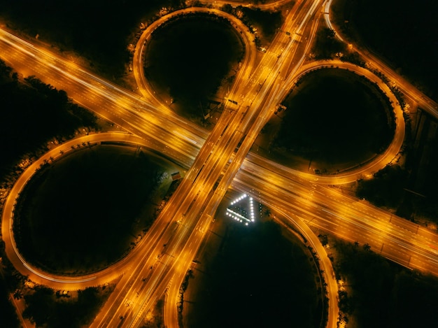 Photo light trails on road at night in a road intersection