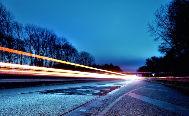 Photo light trails on road at night