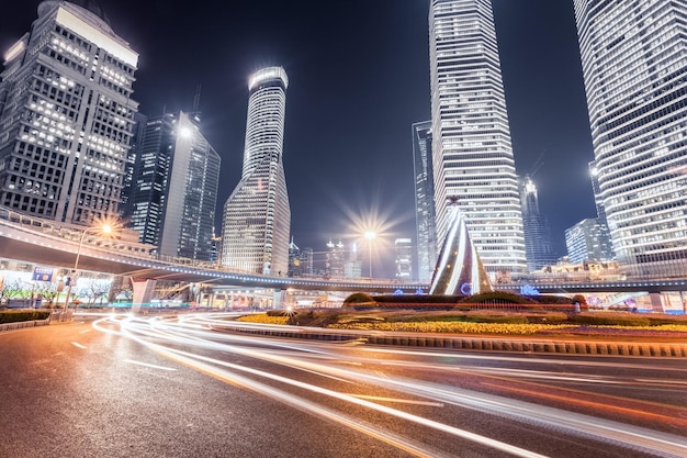 Light trails on the roundabout with modern financial buildings in shanghai at night