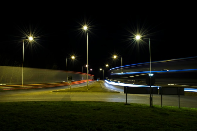 Light trails on street against sky at night