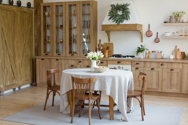 Light wooden kitchen interior with table on the middle of dinning room Beautiful kitchen interior design