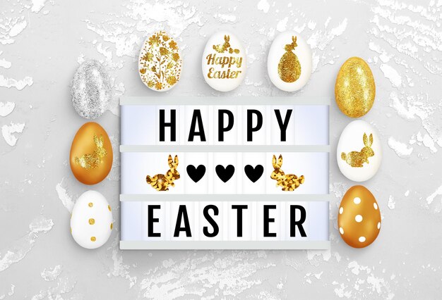 Lightbox, glanzende eieren op concrete achtergrond. Tekstframe van de lightbox met de inscriptie Happy Easter, harten, konijntjes. Advertentiemodel voor de paasvakantie. Bovenaanzicht, close-up, kopieer ruimte