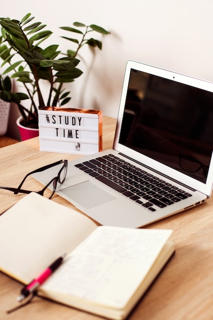 Lightbox with the inscription time to study in the background is a laptop a notebook and a notebook ...