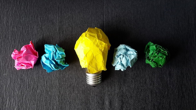 Lightbulb and crumpled papers