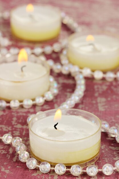 Lighted candles with beads close up