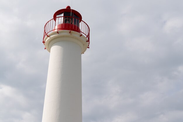 Lighthouse for boat red and white in cloud sky