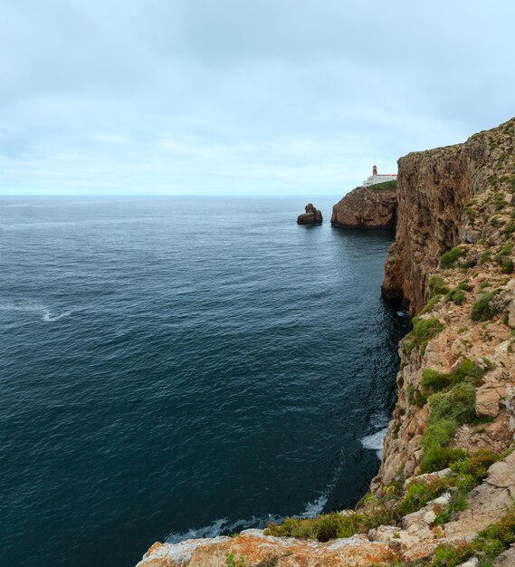 Lighthouse on Cape St. Vincent (is headland in municipality of Sagres, Algarve, southern Portugal). Summer Atlantic coast view. Two shots stitch image.