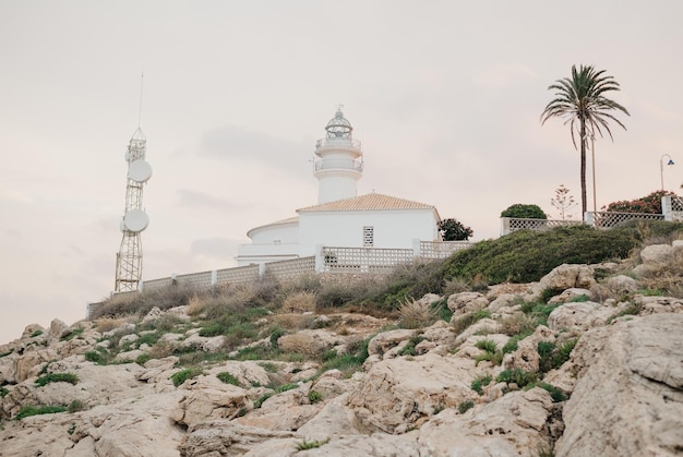 The lighthouse on the cliff in the highland park at sunset in Valencia