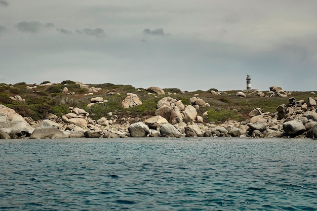 The lighthouse dispersed in the natural and wild coast