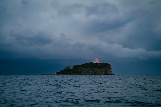 Lighthouse in a foggy sea show the direction  loneliness and hope concept