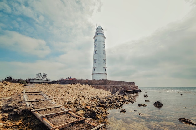 Lighthouse on the sea coast on a bright sunny day