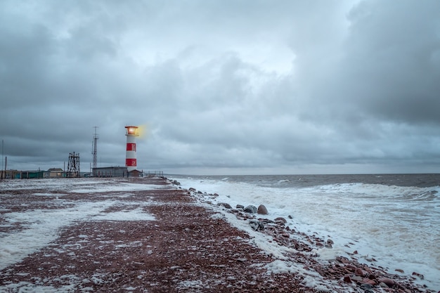 Lighthouse on the shore of the raging White sea on the Kola Peninsula.