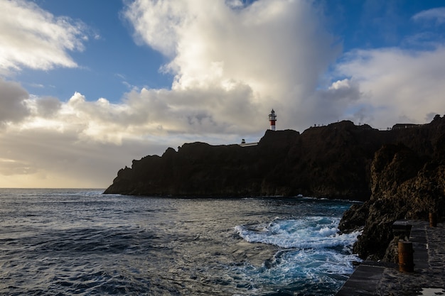 Lighthouse in the sunset. the lighthouse stands beautifully on high rocks