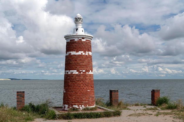 Lighthouse in the village of Rybachy on a sunny summer day Curonian Spit Kaliningrad region Russia