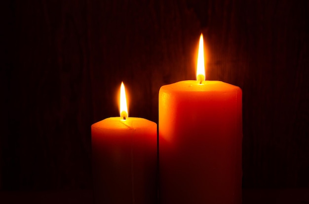 Lighting a candle with a match in the dark copy space