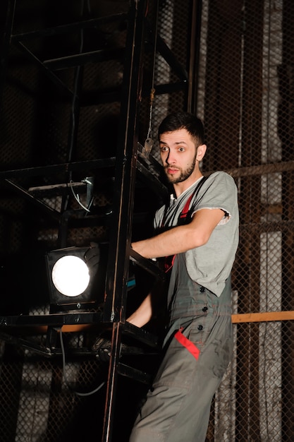 The lighting engineer adjusts the lights on stage behind the scenes.