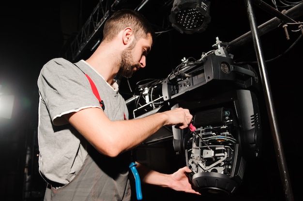 The lighting engineer adjusts the lights on the stage