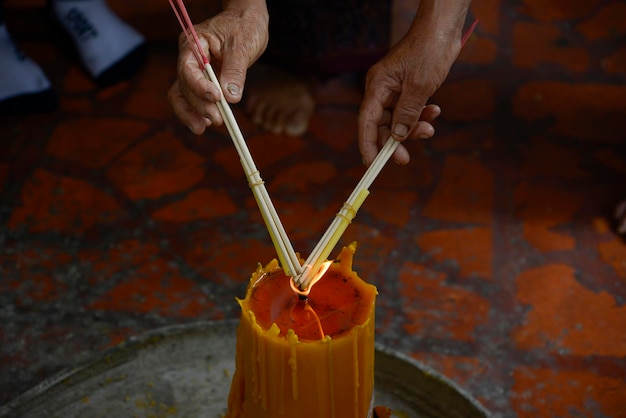 Lighting incense to Buddha